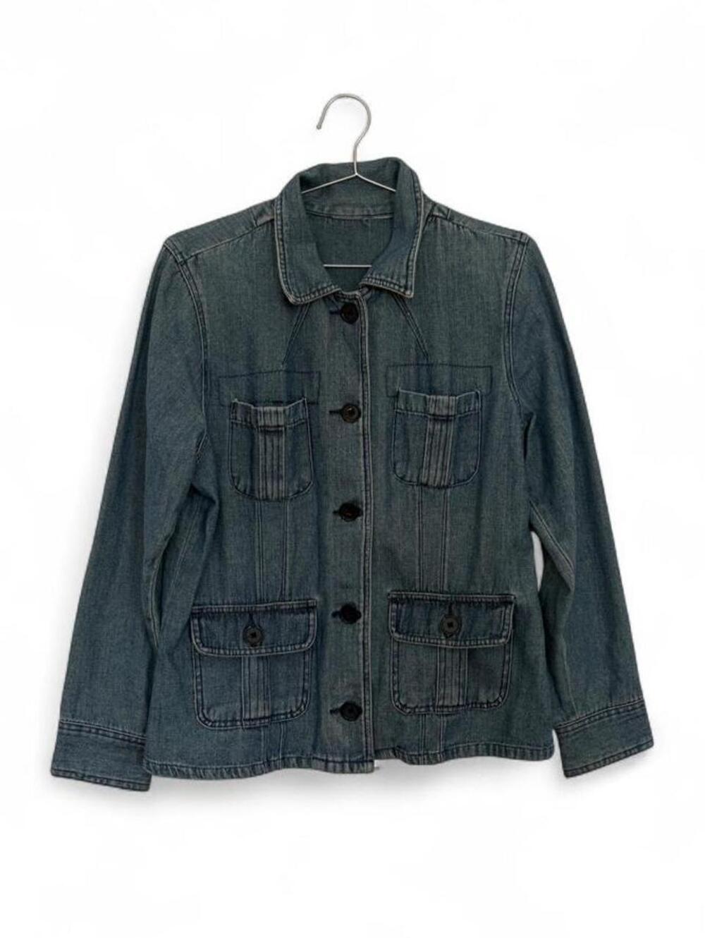 Blue vintage denim jacket with vertical stitching.